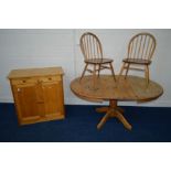 A PAIR OF DISTRESSED ERCOL BLONDE HOOP BACK CHAIRS together with a pine extending pedestal table and