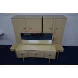 A MID TO LATE 20TH CENTURY CREAM FOUR PIECE BEDROOM SUITE, comprising two double door wardrobes,