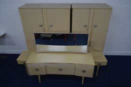 A MID TO LATE 20TH CENTURY CREAM FOUR PIECE BEDROOM SUITE, comprising two double door wardrobes,