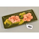 A MOORCROFT POTTERY PEN TRAY OF RECTANGULAR FORM, coral hibiscus design on a green ground, impressed