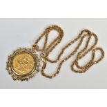 A SOVEREIGN PENDANT AND CHAIN, the full 1958 sovereign within a 9ct gold foliate surround