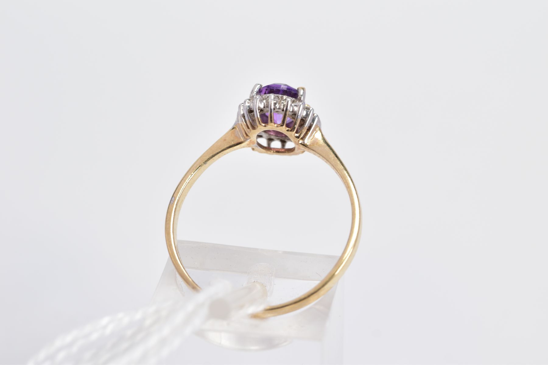 A 9CT GOLD AMETHYST AND DIAMOND CLUSTER RING, the oval amethyst within a single cut diamond - Image 3 of 3