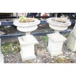 A PAIR OF COMPAGNA STYLE COMPOSITE PLANTERS, on a three piece square column, height 92cm