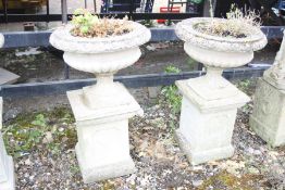 A PAIR OF COMPAGNA STYLE COMPOSITE PLANTERS, on a three piece square column, height 92cm