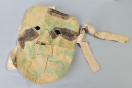 A GERMAN WWI/II ERA CANVAS/CLOTH CAMOFLOUGE SNIPER MASK, to be worn under the helmet etc, faded