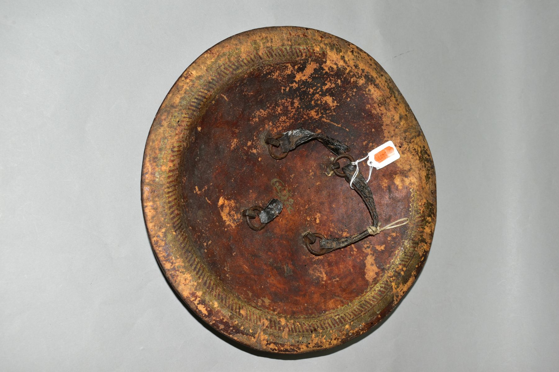 AN INDIAN LEATHER SHEILD WITH FOUR IRON BOSSES, probably 19th Century, leather straps verso and - Image 4 of 5