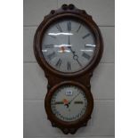 A LATE VICTORIAN SETH THOMAS WALNUT AND ROSEWOOD OFFICE CALENDAR WALL CLOCK, the top with a