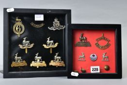 TWO SMALL GLAZED FRAMES containing a number of WWI era cap badges, collar dogs buttons and