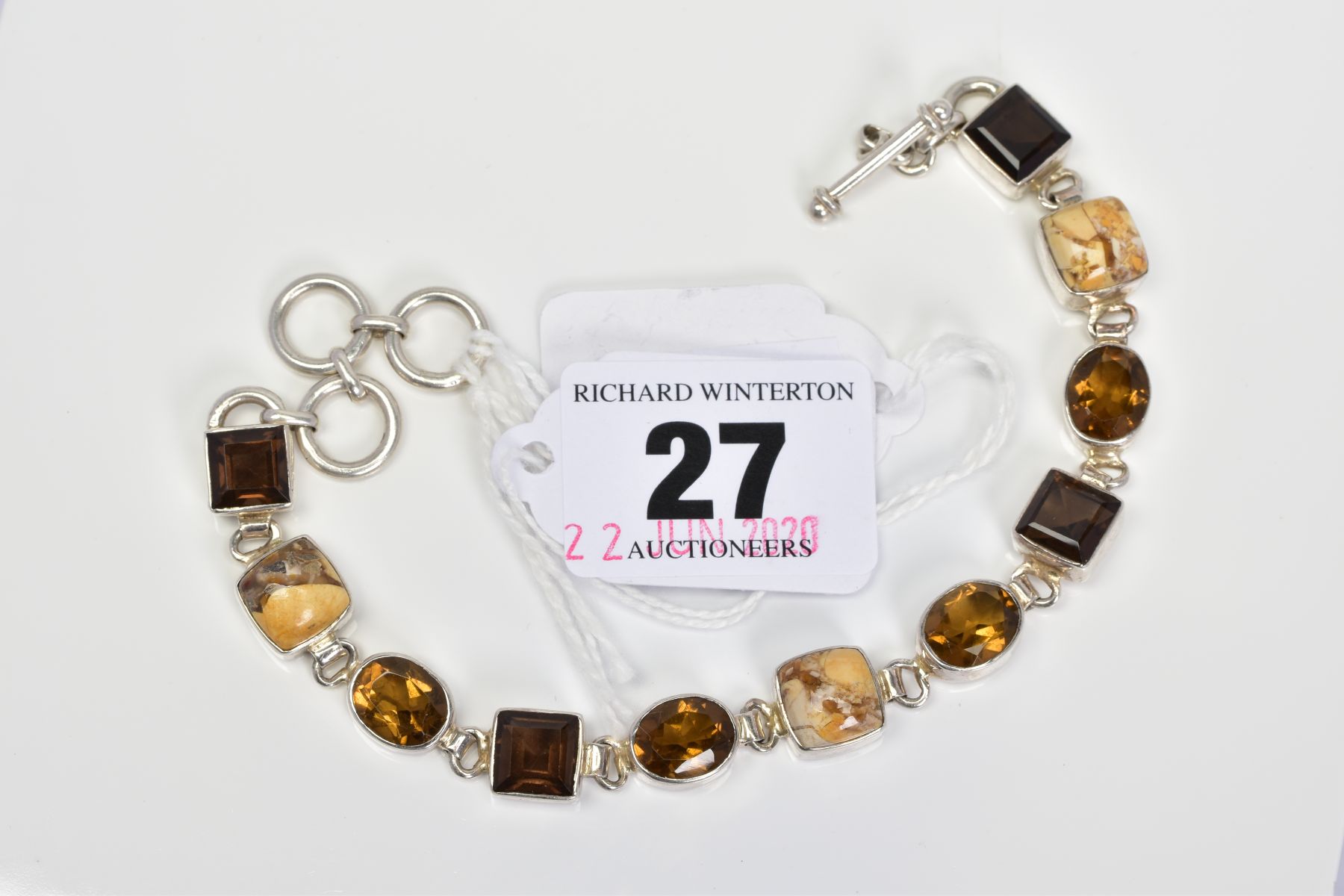 A MULTI GEM BRACELET, designed with collet set gems including square smokey quartz and oval citrine,