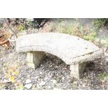 A CURVED COMPOSITE GARDEN BENCH with scroll detailed supports, width 140cm x height 47cm