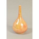 A RUSKIN POTTERY ONION SHAPED VASE, mottled peach ground with iridescent glaze, impressed Ruskin