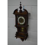 AN EARLY 20TH CENTURY OAK WALL CLOCK, the white enamel and brassed dial with Roman numerals,
