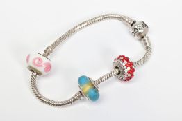 A PANDORA CHARM BRACELET, suspending one glass Pandora charm and two non designer charms, bracelet