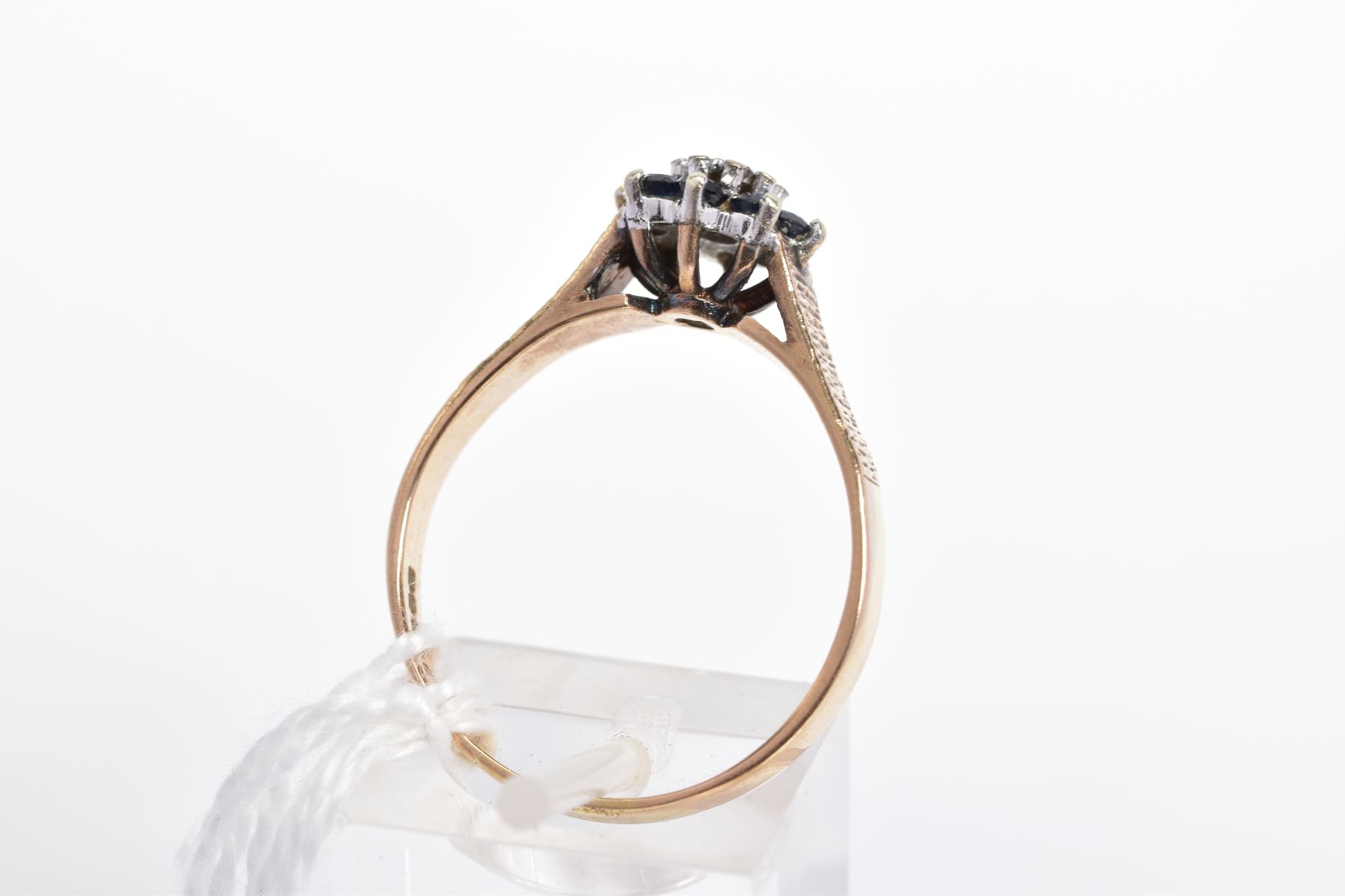 A 9CT GOLD SAPPHIRE AND DIAMOND CLUSTER RING, the central single cut diamond in an illusion - Image 3 of 3