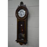AN EARLY 20TH CENTURY MAHOGANY WALL CLOCK with a white enamel dial with Roman numerals, height