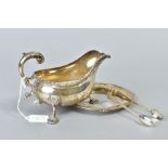 AN EDWARDIAN SILVER SAUCE BOAT, gadrooned rim, 'S' scroll handle, on three cabriole legs with