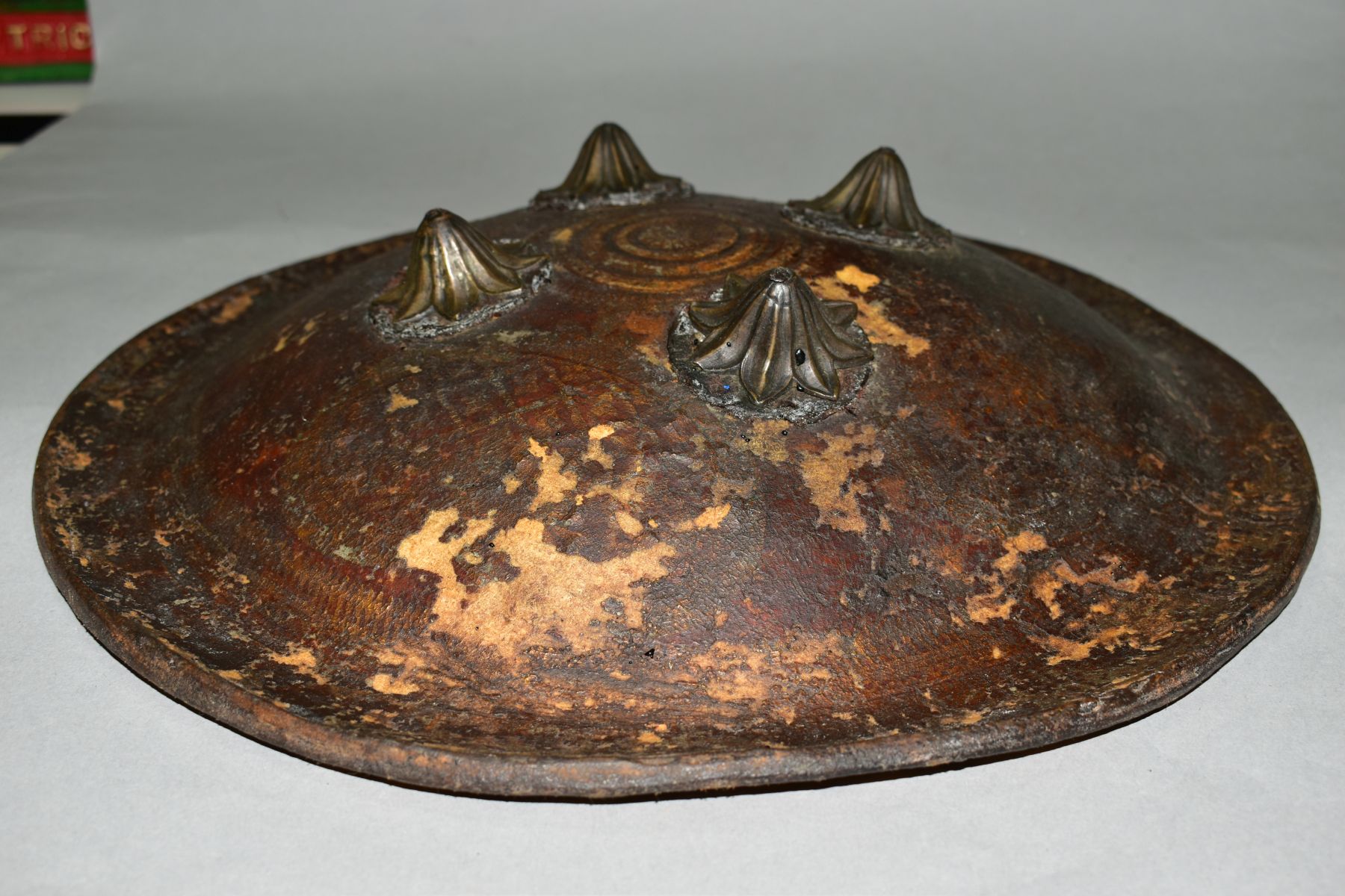 AN INDIAN LEATHER SHEILD WITH FOUR IRON BOSSES, probably 19th Century, leather straps verso and - Image 2 of 5