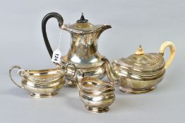 A GEORGE V SILVER FOUR PIECE TEA SERVICE, of oval form with a cast Celtic rim, tea pot with ivory
