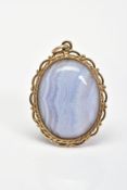 A BLUE LACE AGATE PENDANT, the oval blue lace agate cabochon within a rope twist and scalloped and
