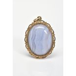 A BLUE LACE AGATE PENDANT, the oval blue lace agate cabochon within a rope twist and scalloped and