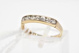 A 9CT GOLD SEVEN STONE CUBIC ZIRCONIA RING, designed as seven channel set circular colourless