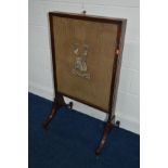 A REGENCY MAHOGANY AND EBONY INLAID FIRESCREEN with a single sliding panel and needlework coat of