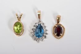 THREE PENDANTS, the first of 9ct gold set with an oval cut garnet within a rope twist surround, with