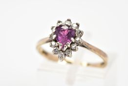 A 9CT GOLD CLUSTER RING, with a central pear cut ruby and single cut diamond surround, to the
