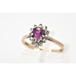 A 9CT GOLD CLUSTER RING, with a central pear cut ruby and single cut diamond surround, to the