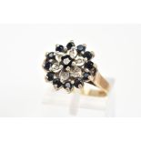 A 9CT GOLD SAPPHIRE AND DIAMOND RING, of cluster design set with thirteen circular cut sapphires and