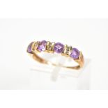 AN AMETHYST AND DIAMOND RING, designed as a line of four circular amethysts with bar spacers set
