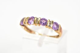 AN AMETHYST AND DIAMOND RING, designed as a line of four circular amethysts with bar spacers set