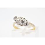 A FOUR STONE DIAMOND RING, of cross over design featuring a row of four diamonds, two brilliant cut,