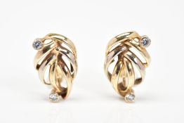 A PAIR OF EARRINGS, each of open work leaf design set with two cubic zirconia stones with post and