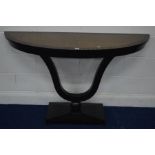 A MODERN HARDWOOD AND EBONISED EFFECT DEMI LUNE CONSOLE TABLE, on a u-shaped and rectangular base,
