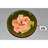 A MOORCROFT POTTERY FOOTED BOWL, 'Hibiscus' pattern on green ground, impressed backstamps,