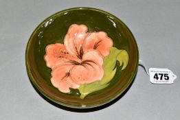 A MOORCROFT POTTERY FOOTED BOWL, 'Hibiscus' pattern on green ground, impressed backstamps,