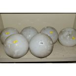 A SET OF SIX OPAQUE WHITE GLASS SPHERICAL CEILING LIGHT SHADES WITH METAL FITTINGS, approximate