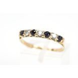 A 9CT GOLD SAPPHIRE AND CUBIC ZIRCONIA RING, designed as a line of four circular sapphires