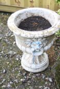 A LARGE COMPOSITE TWO PIECE GARDEN URN with lions head detail to sides, diameter 54cm x height 65cm