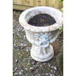 A LARGE COMPOSITE TWO PIECE GARDEN URN with lions head detail to sides, diameter 54cm x height 65cm