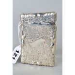 AN EDWARDIAN SILVER CARD CASE, of wavy rectangular outline, engraved with flower heads, vacant