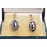 A PAIR OF CULTURED PEARL EARRINGS, each suspending a dyed black cultured pearl with post and