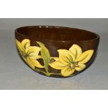 A MOORCROFT POTTERY OVAL BOWL, 'Bermuda Lily' pattern on brown ground, impressed backstamp, height