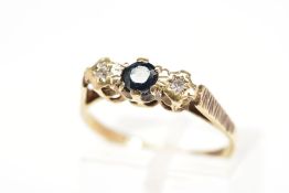 A 9CT GOLD SAPPHIRE AND DIAMOND RING, the central circular sapphire flanked by single cut diamonds