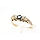 A 9CT GOLD SAPPHIRE AND DIAMOND RING, the central circular sapphire flanked by single cut diamonds