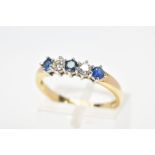 AN 18CT GOLD SAPPHIRE AND DIAMOND FIVE STONE RING, designed as three circular sapphires