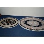 A LARGE G H FIRTH OVAL WOOLLEN CHINESE BLACK GROUND RUG, 250cm x 160cm and a similar smaller rug (