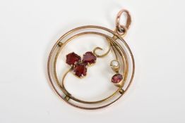 AN EARLY 20TH CENTURY GARNET AND SPLIT PEARL PENDANT, of circular open work design featuring