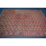 A LATE 19TH/EARLY 20TH CENTURY TEKKE TURKMAN RED GROUND RUG, 280cm x 207cm (low pile in places but